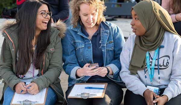 Image of 3 ladies from different cultures conversing